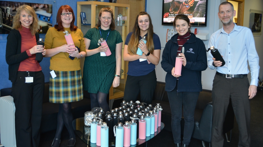 Members of staff from British Glass and Glass Technology Services pose with their free glass water bottles